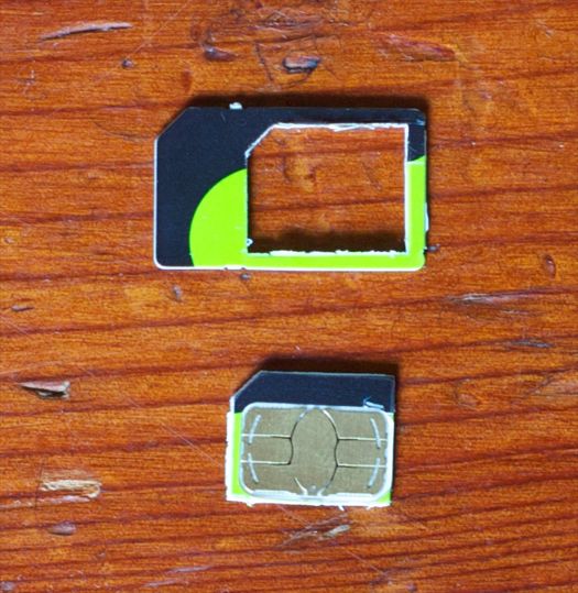The newly created micro SIM (bottom) and the left-over plastic shell of the SIM card (top)